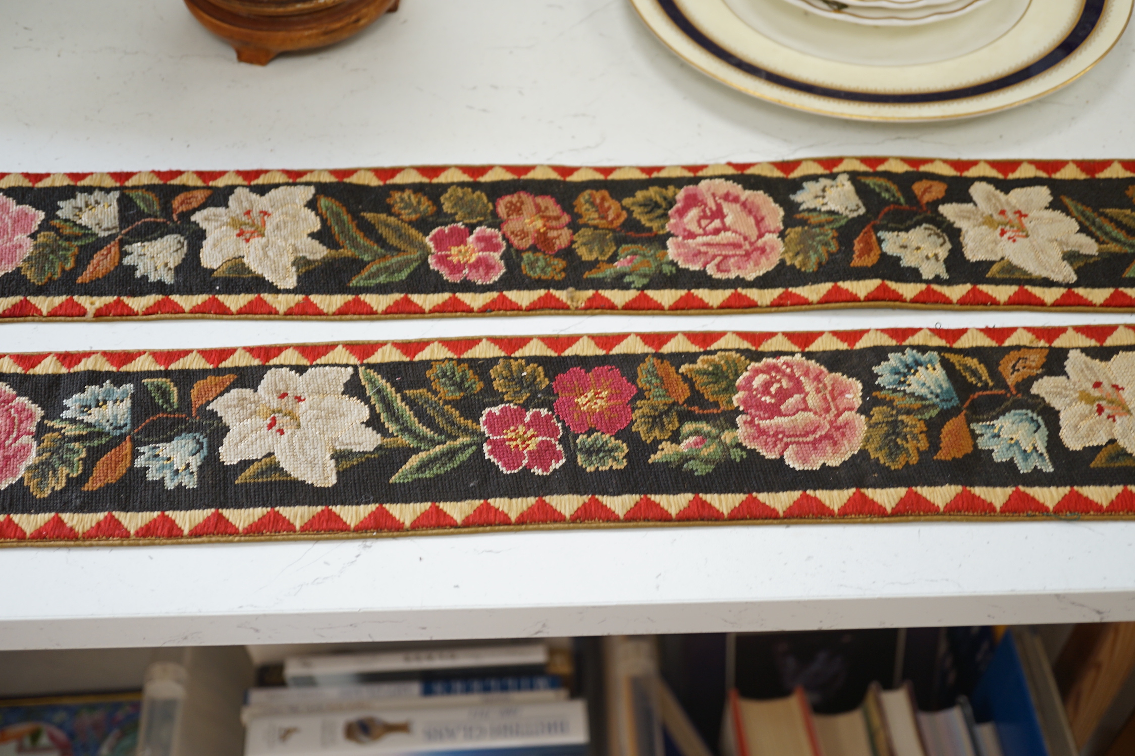 A pair of Victorian petit pointe embroidered bell pulls, 163cm including gilt metal hanger and silk rosette